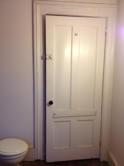 Bathroom Before: View of the door from the inside.